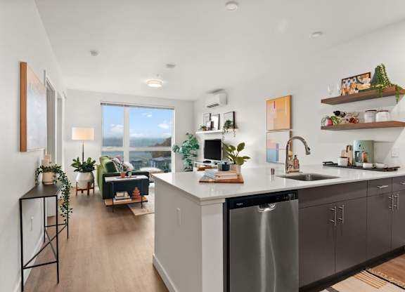 A modern kitchen with a large island and stainless steel appliances at Cru at Willows Apartments, Redmond