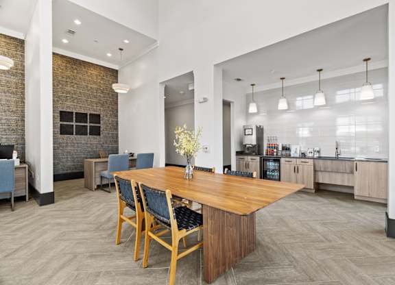 A dining room with a wooden table and chairs.