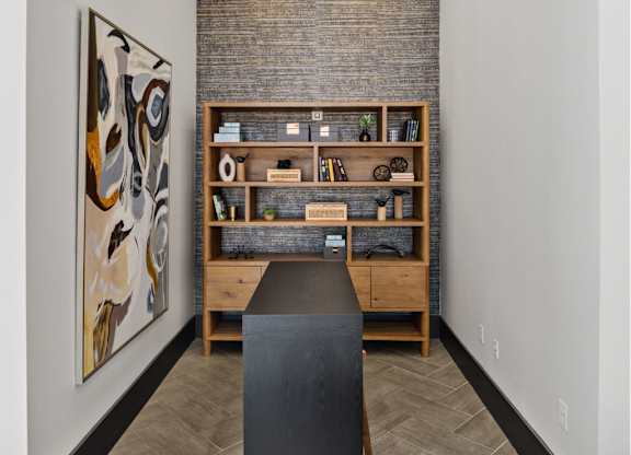 A room with a brick wall and a bookshelf.