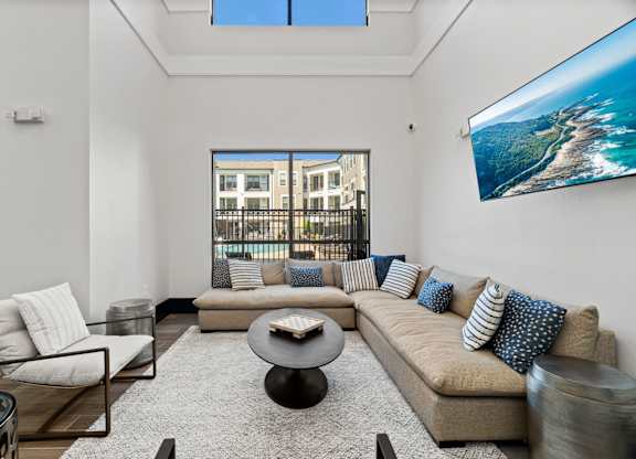 A modern living room with a large sofa and a coffee table.