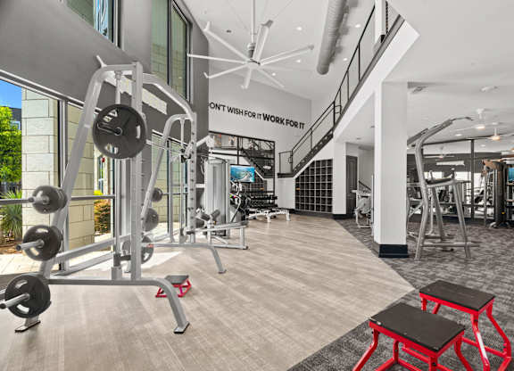 A gym with a variety of equipment including a weight bench and a treadmill.