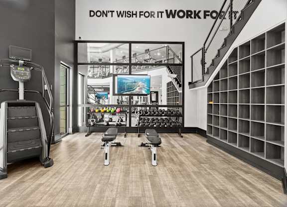 A gym with a sign that says "Don't wish for it, work for it".