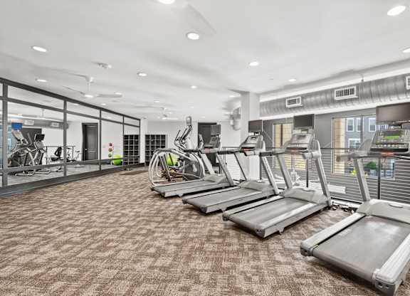 A gym with treadmills and other exercise equipment.