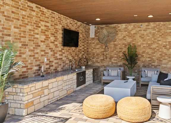 A patio with a fireplace and seating area.