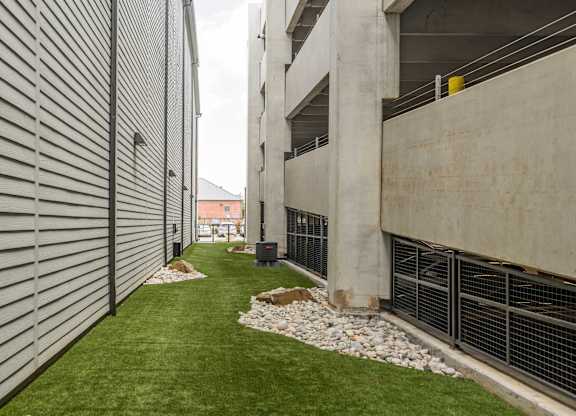 A concrete building with a green lawn in front.