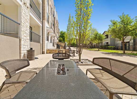 A view of a patio with a table and chairs.
