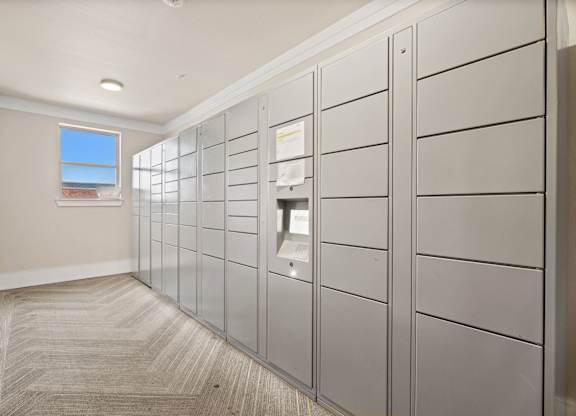 A hallway with a row of lockers on the right side.