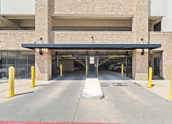 A parking garage entrance with a sign that says "Entrance 1".
