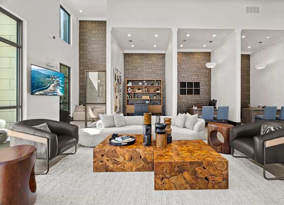 A modern living room with a wooden coffee table in the center.