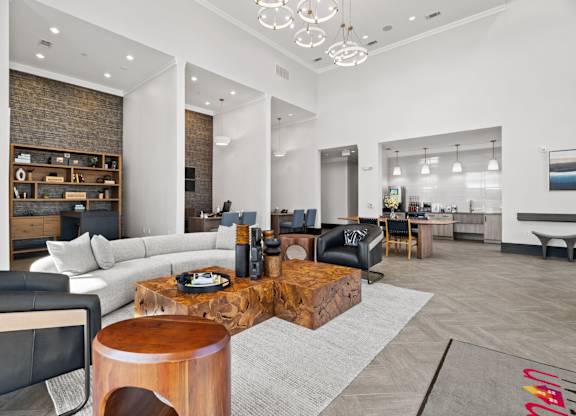 A modern living room with a wooden coffee table and a black leather couch.
