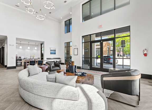 A modern living room with a curved sofa and a fireplace.