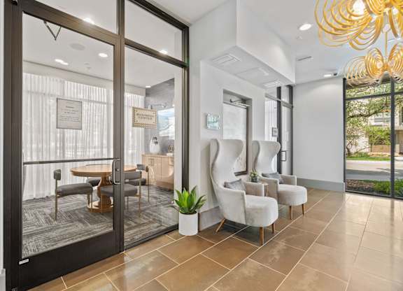 A modern living room with a glass door leading to a balcony.