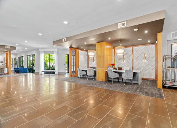 A spacious lobby with a marble floor and a reception desk.