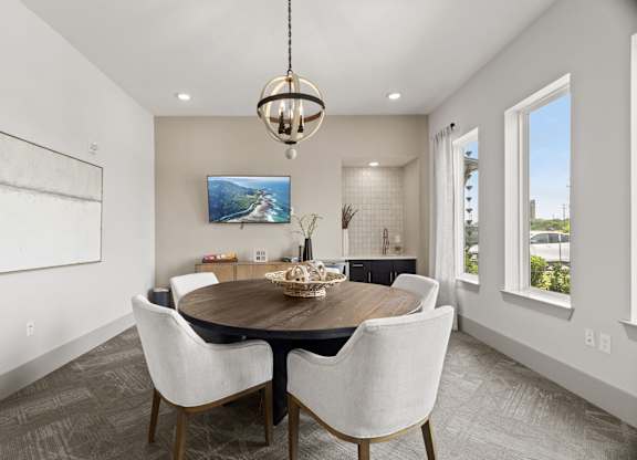 A modern dining room with a wooden table and chairs.