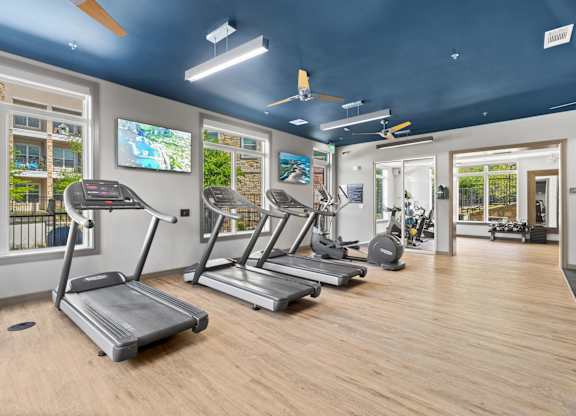 A gym with treadmills and exercise equipment.