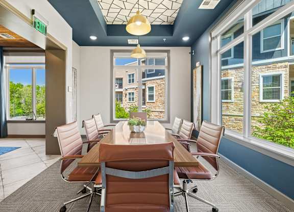A conference room with a long table and chairs.
