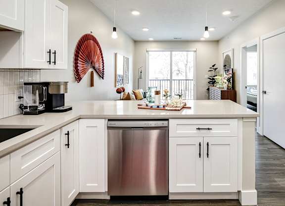 A modern kitchen with white cabinets and a large island.
