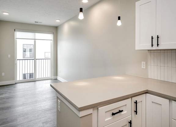 A kitchen with white cabinets and a countertop.