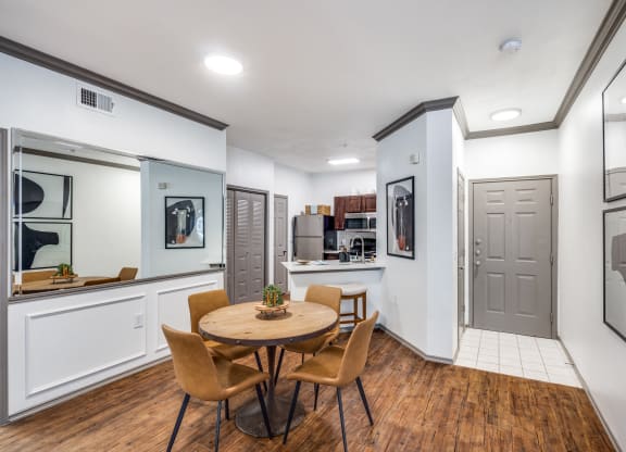 a dining room with a table and chairs and a kitchen