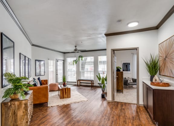 the view of a living room with wood floors and white walls