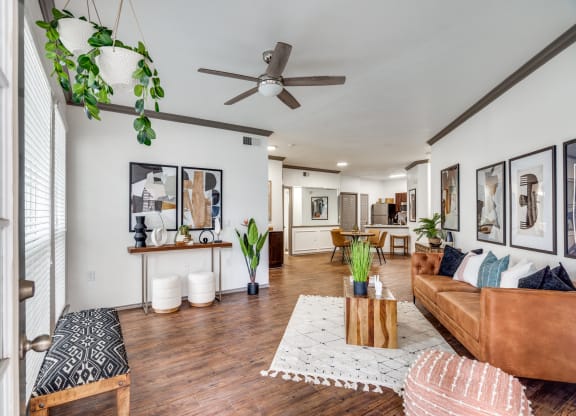 a living room with a couch and a ceiling fan
