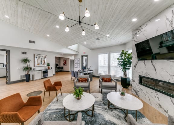 a living room with couches and chairs and a fireplace