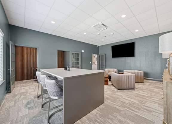 A conference room with a long table and chairs.