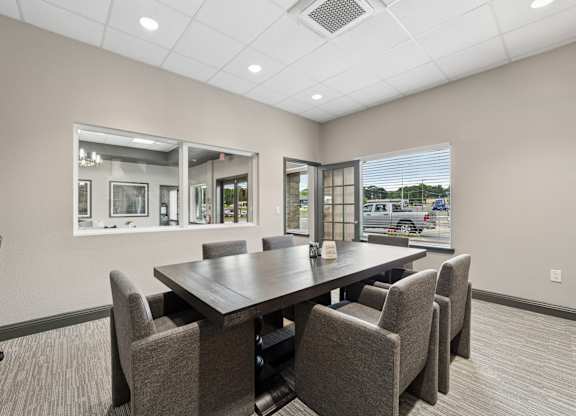 A conference room with a large table and chairs.