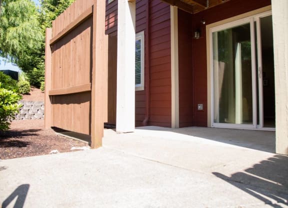 a porch in front of a house with a glass door