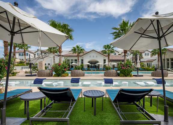 A poolside area with lounge chairs and umbrellas.