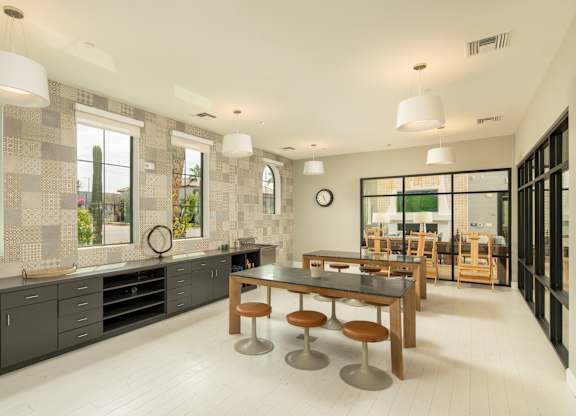 A modern kitchen with a dining table and chairs.