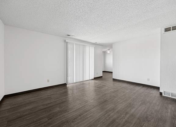 A room with wooden floors and white walls.