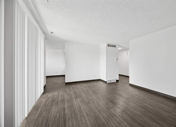 A room with white walls and wood flooring.