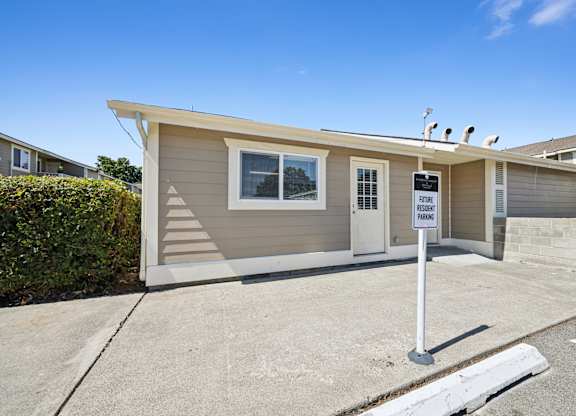 A small house with a sign that says