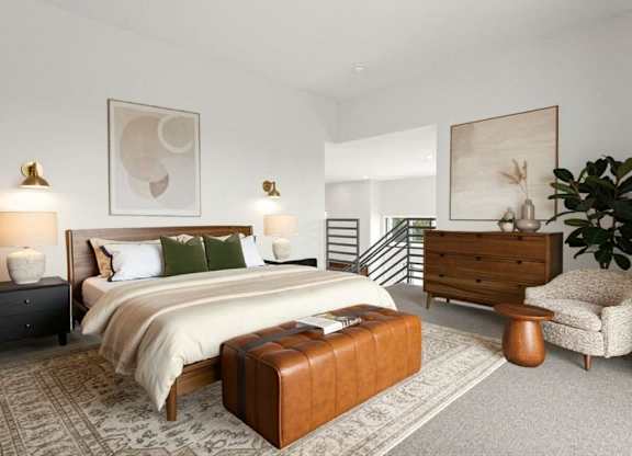 A bedroom with a large bed, a chair, and a painting on the wall.