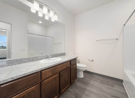A bathroom with a sink, toilet, and bathtub.