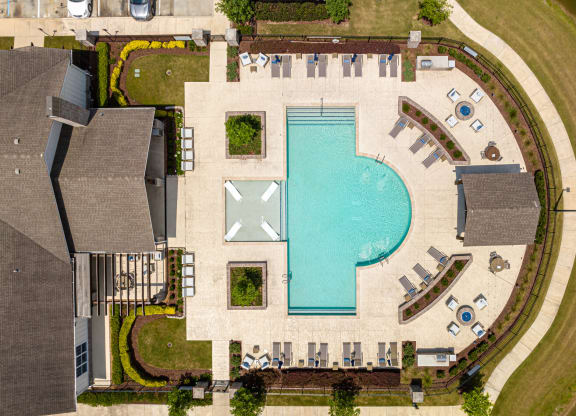 arial view of a resort style swimming pool with chaise lounge chairs