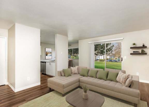 A living room with a couch, a coffee table, and a window.