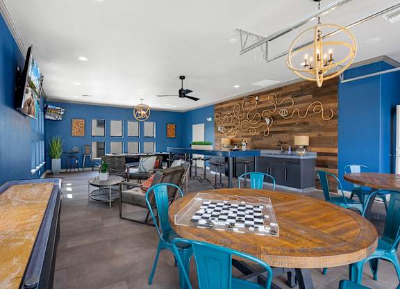 A room with a pool table and a chess board on the table.