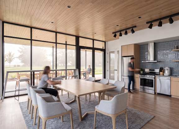 A modern kitchen with a dining table and chairs.