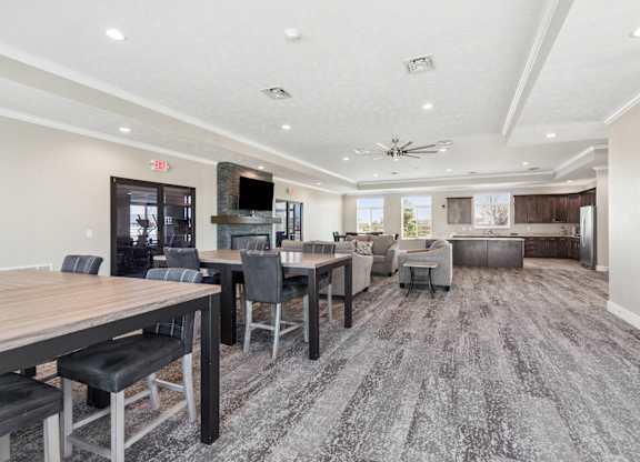 A spacious room with a long table and chairs.