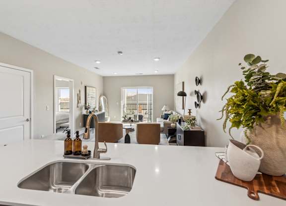A kitchen with a white countertop and a sink.