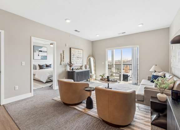 A modern living room with a large window and a view of the city.