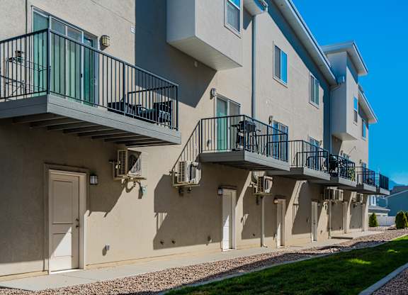 an exterior view of an apartment building with balconies and stairs