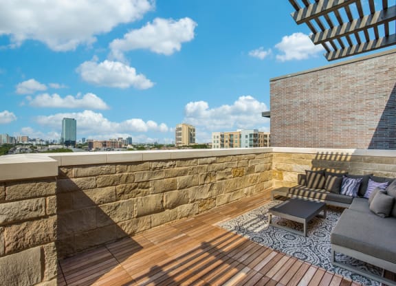a roof deck with a view of the city