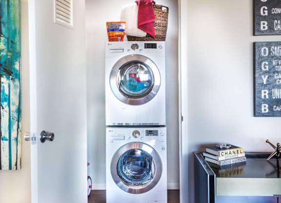 A white washing machine with a basket on top of it.