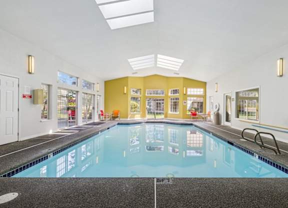 A large indoor swimming pool with a tiled floor. at Saratoga, Everett, WA, 98204