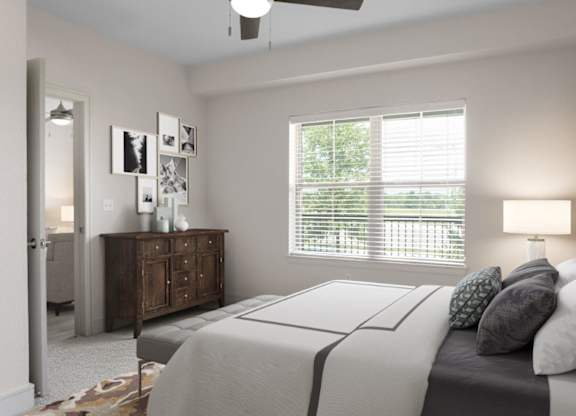 A bedroom with a bed, dresser, and window with blinds.
