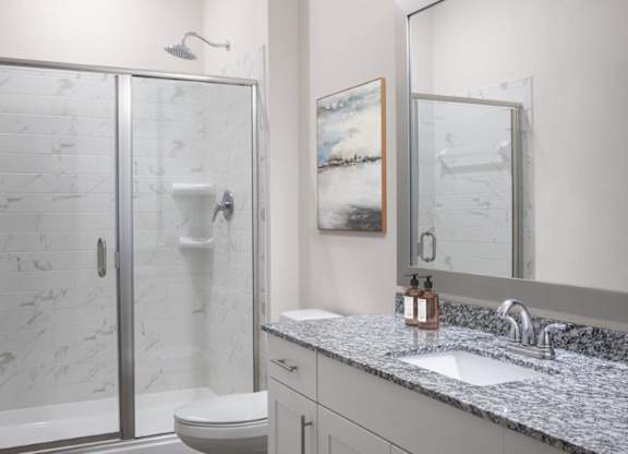 A bathroom with a marble toilet and a sink.