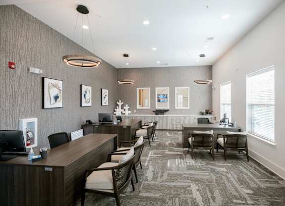 A reception area with a desk and chairs.